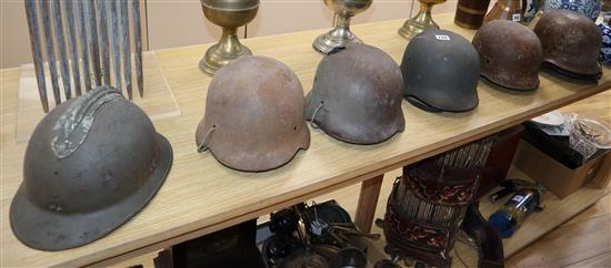 Seven various WWI and WWII helmets